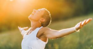 a woman taking in the sunlight smiling