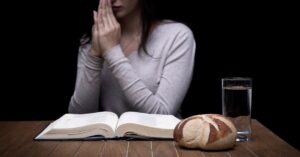 woman fasting and praying before she eats