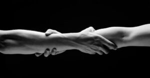 two people holding each others arms
