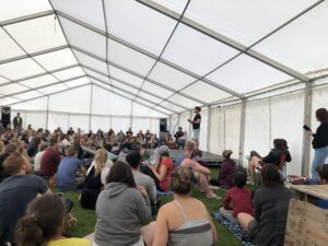 A crowds full of people listening to a speaker on stage
